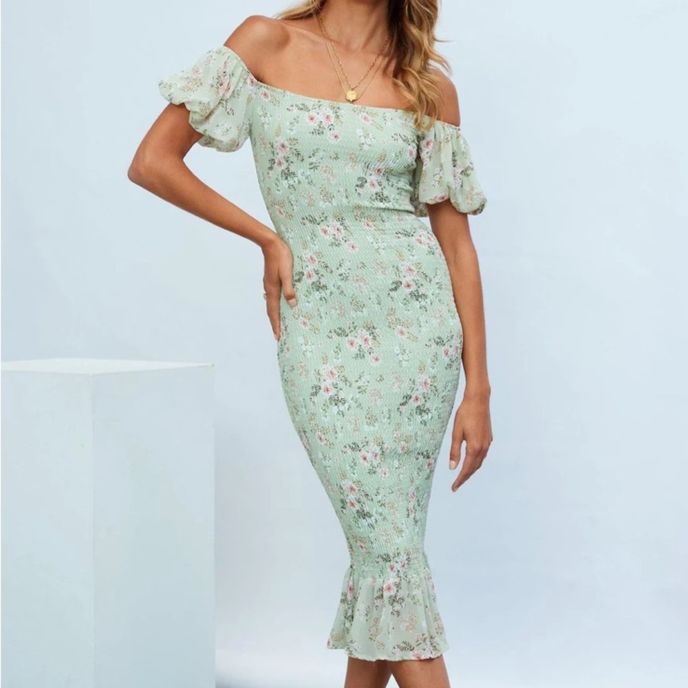 Beautiful floral smocked dress. New with tags. Not maternity but bump friendly.